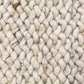 Cream wool rug with chunky loop pile texture and intertwined yarn details