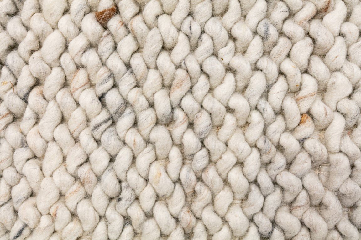 Cream wool rug with chunky loop pile texture and intertwined yarn details