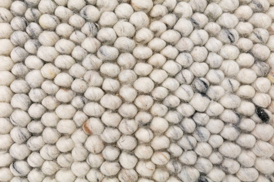 Light grey wool rug with dense round-loop pile and subtle flecks