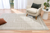 Light gray area rug with concentric square pattern and flat-woven border