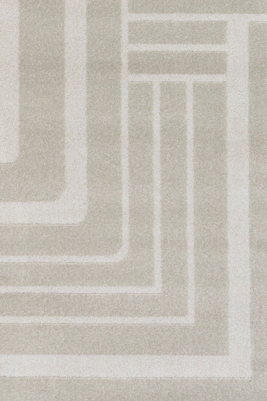 Light gray area rug with interlocking concentric square line pattern