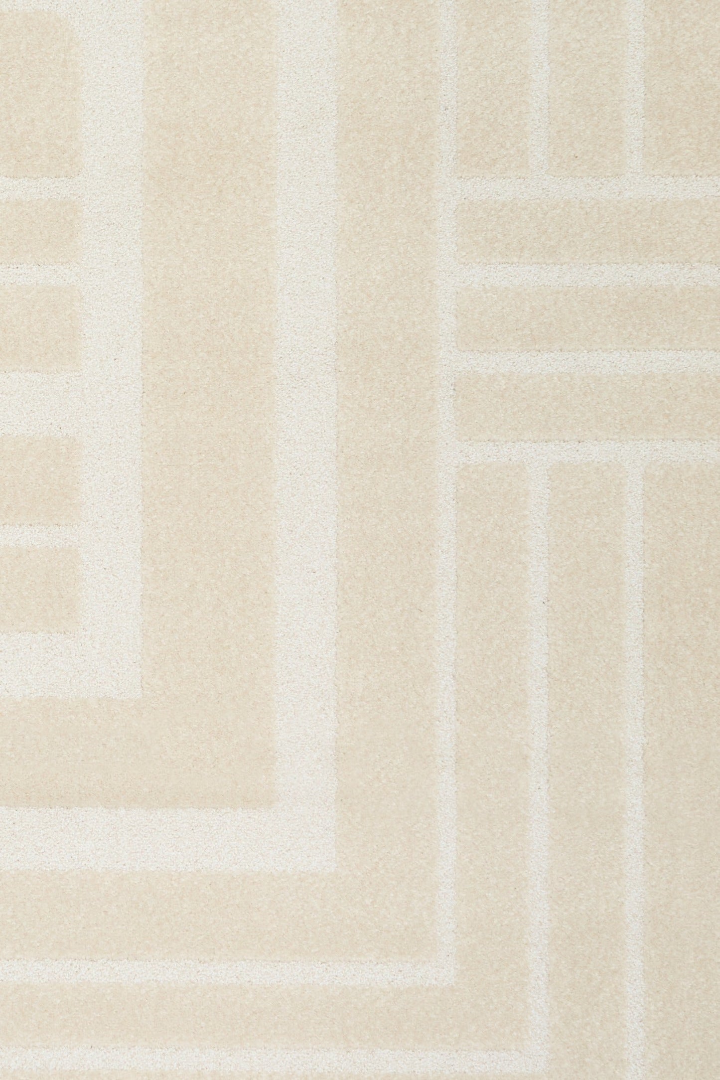 Ozlo ecru patterned area rug corner with Greek key border
