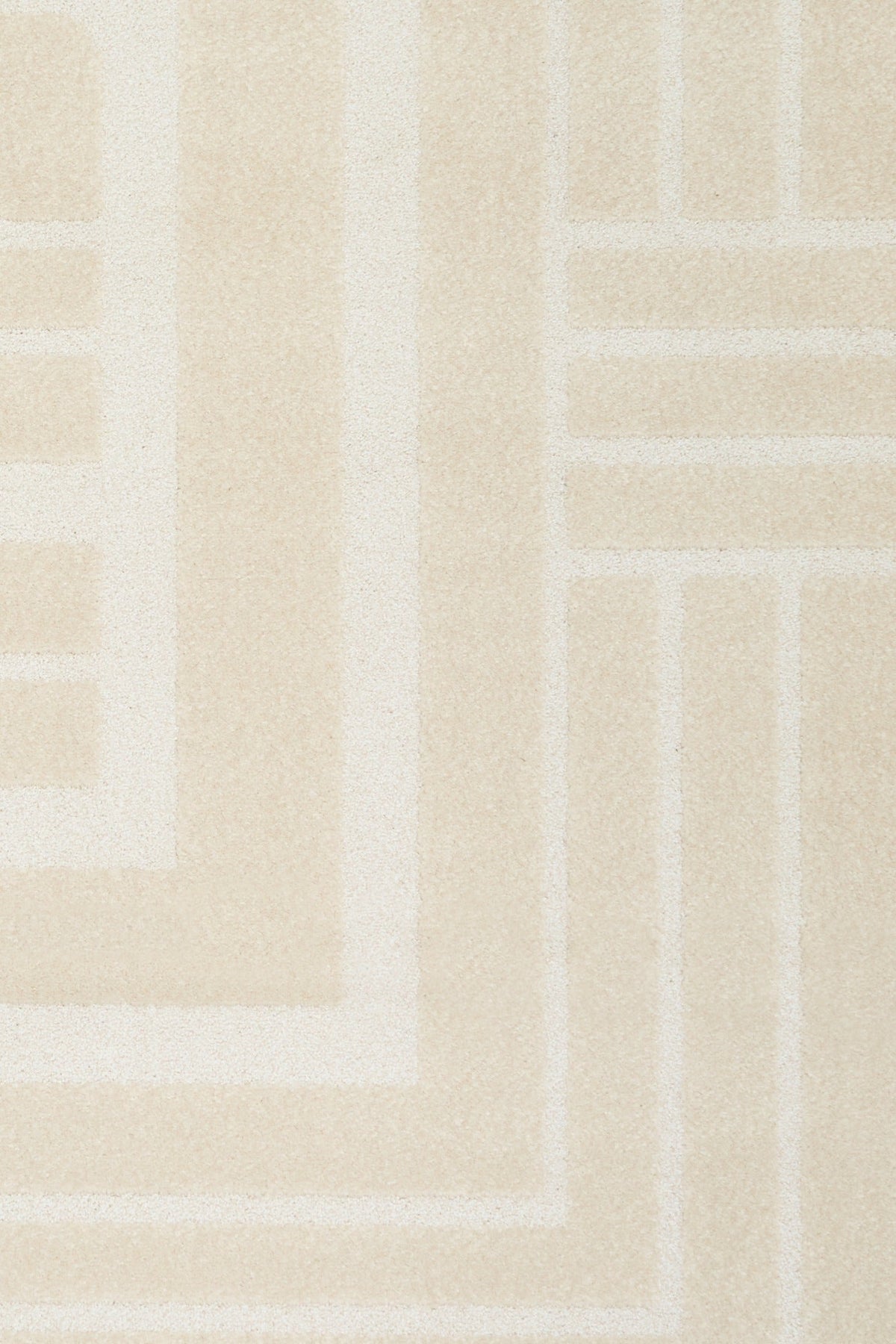 Ozlo ecru patterned area rug corner with Greek key border