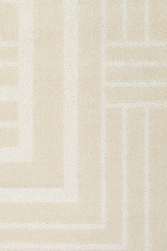 Ozlo ecru patterned area rug corner with Greek key border