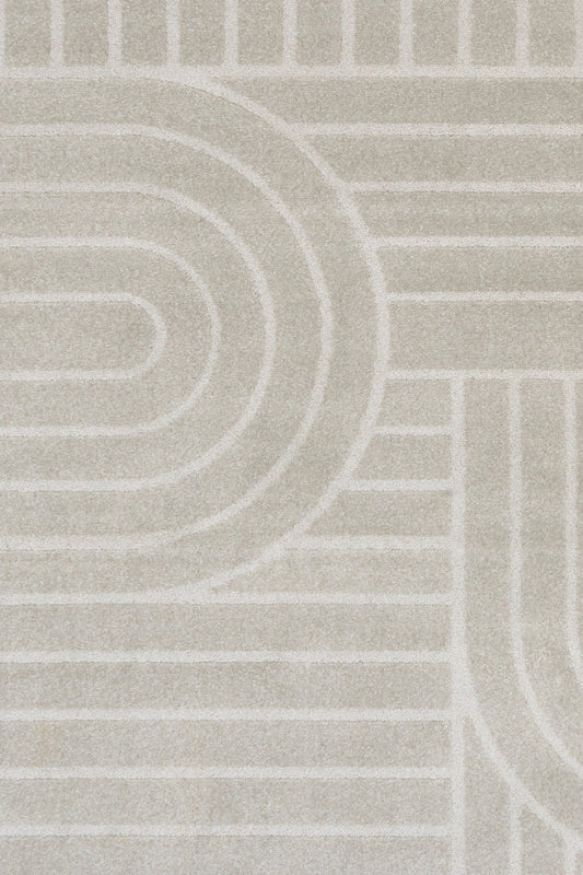 Close-up of light gray rug pattern with concentric arcs and stripe details
