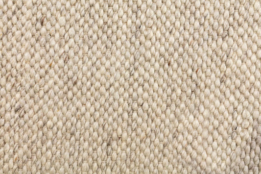 Stone beige wool rug close-up showing dense looped weave texture