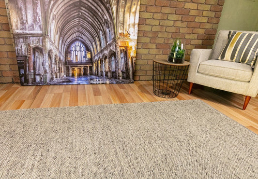 Smoke wool rug in a neutral light gray-beige tone, woven flat surface
