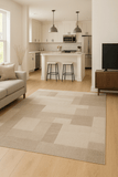 Patchwork woven linen rug with beige, cream, and taupe blocks and subtle border