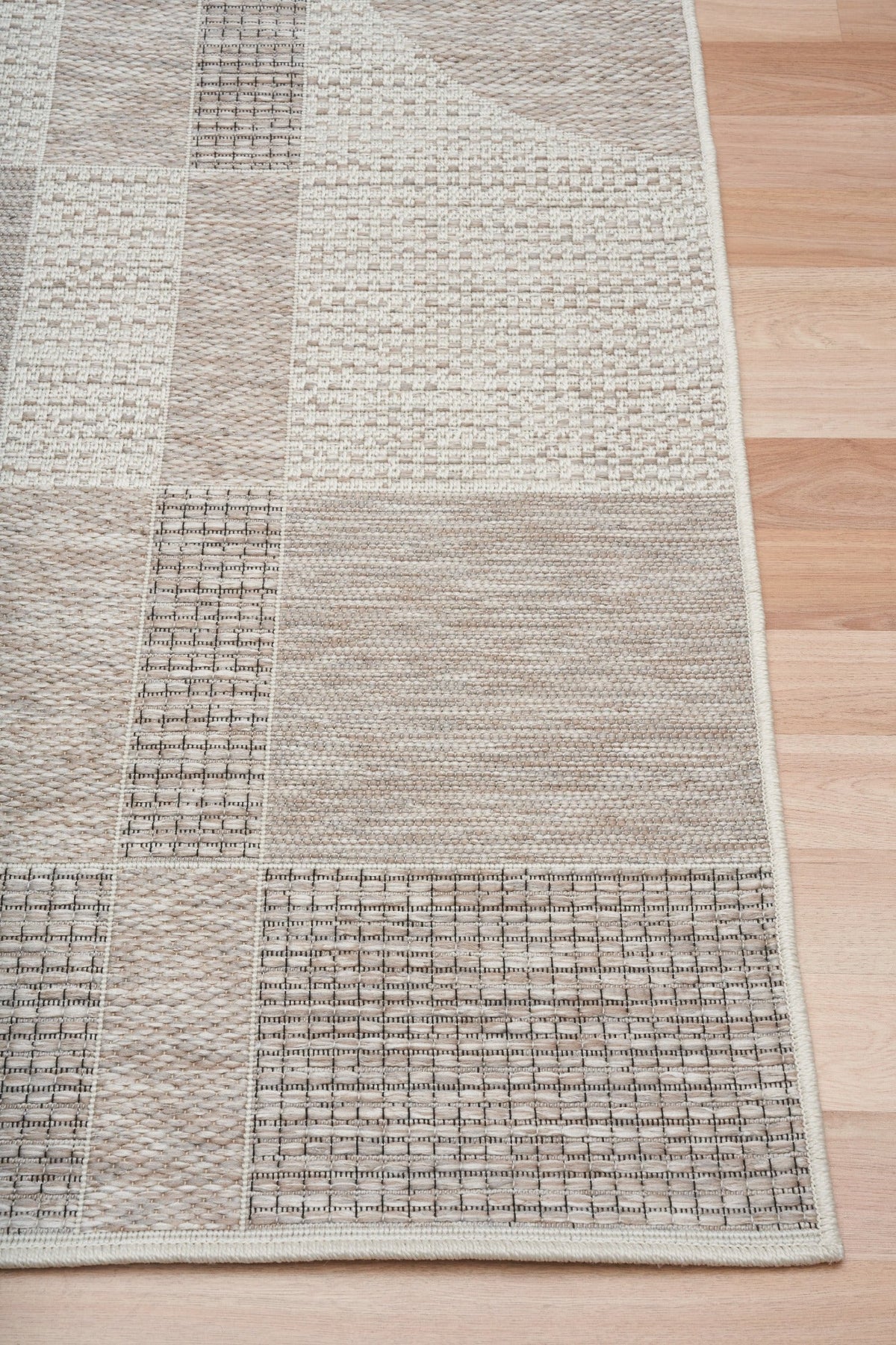 Patchwork linen rug with multitone bands and dotted texture, bordered edge