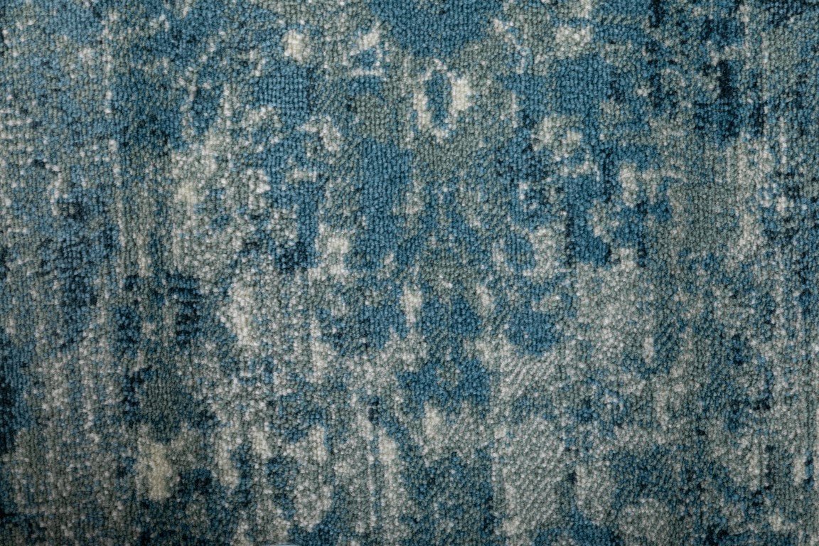 Close-up of blue rug texture with mottled abstract design | Raffia 7444 Sky Modern Polypropylene Area Rug - Rugs Point Australia
