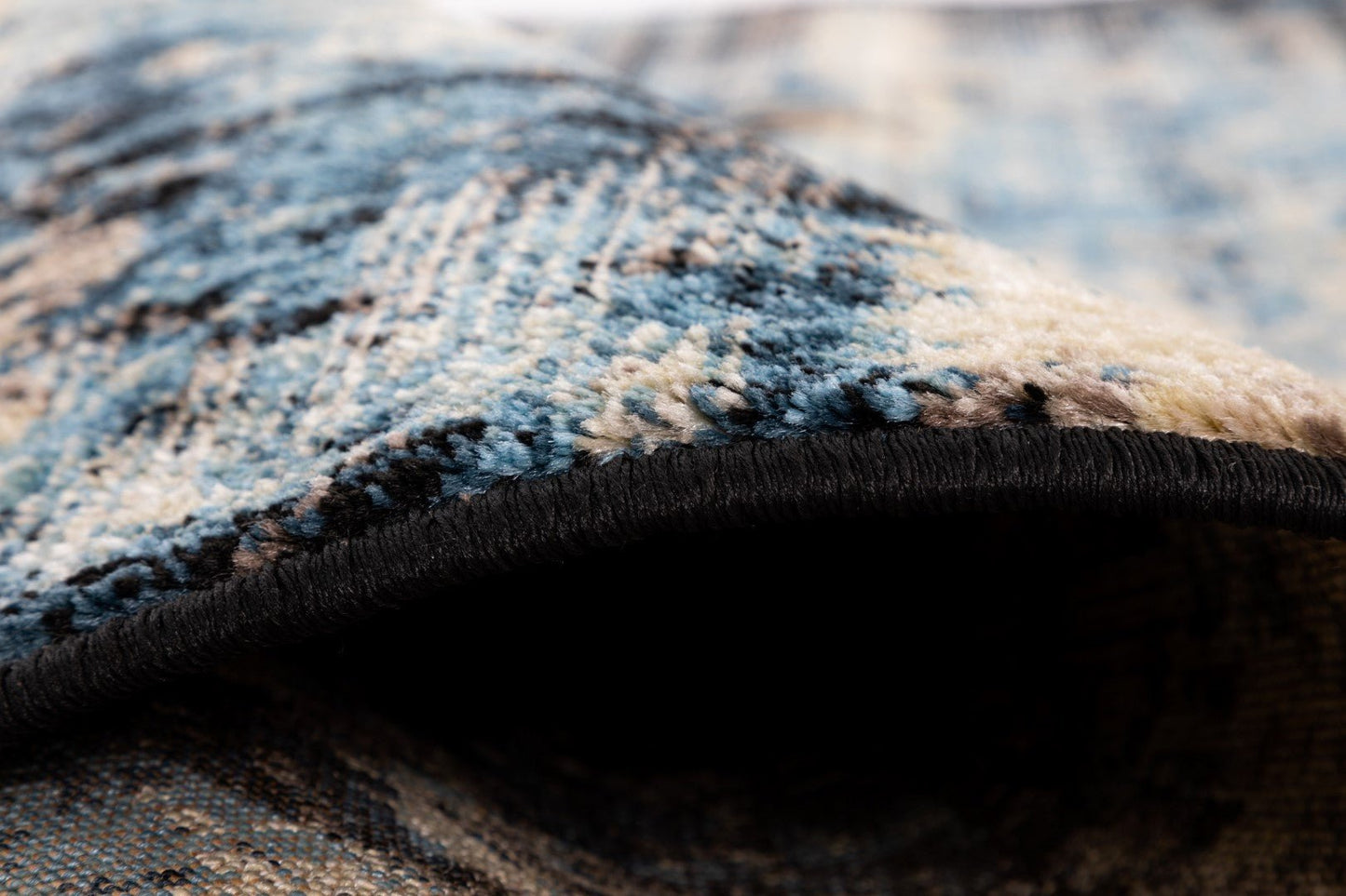 Close-up of rug pile showing soft blue threads with black bound backing | Raffia Mat 1440 Sky Modern Abstract Living Room Rug - Rugs Point Australia