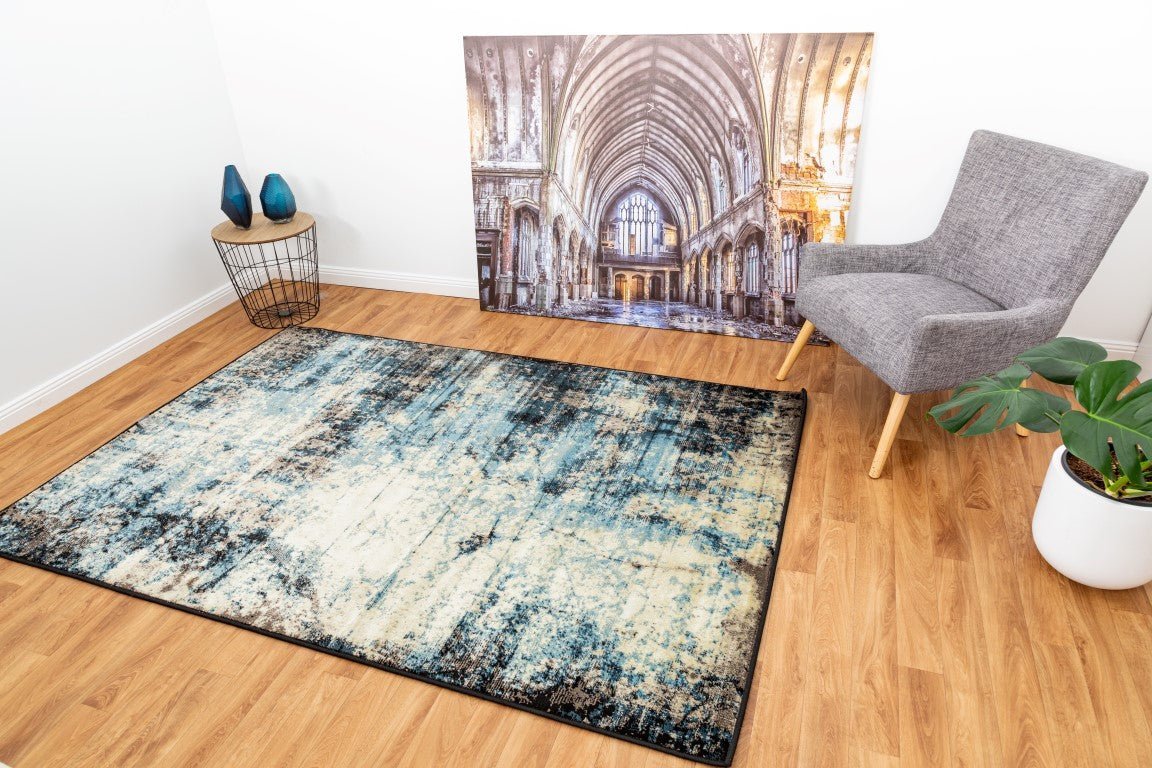 Rectangular area rug with distressed blue and cream pattern and black border | Raffia Mat 1440 Sky Modern Abstract Living Room Rug - Rugs Point Australia