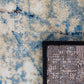 Rug corner detail with black bound edge and blue/cream distressed surface | Raffia Mat 1440 Sky Modern Abstract Living Room Rug - Rugs Point Australia