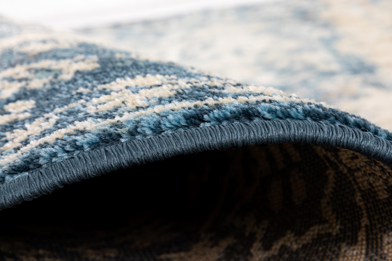 Rolled edge of sky blue and cream rug showing thick plush pile | Raffia Rug 0444 Sky Textured Woven Floor Rug - Rugs Point Australia