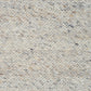 Light grey speckled area rug surface with fine flecked pattern