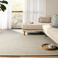 Light grey speckled area rug with flatwoven texture and short, even pile