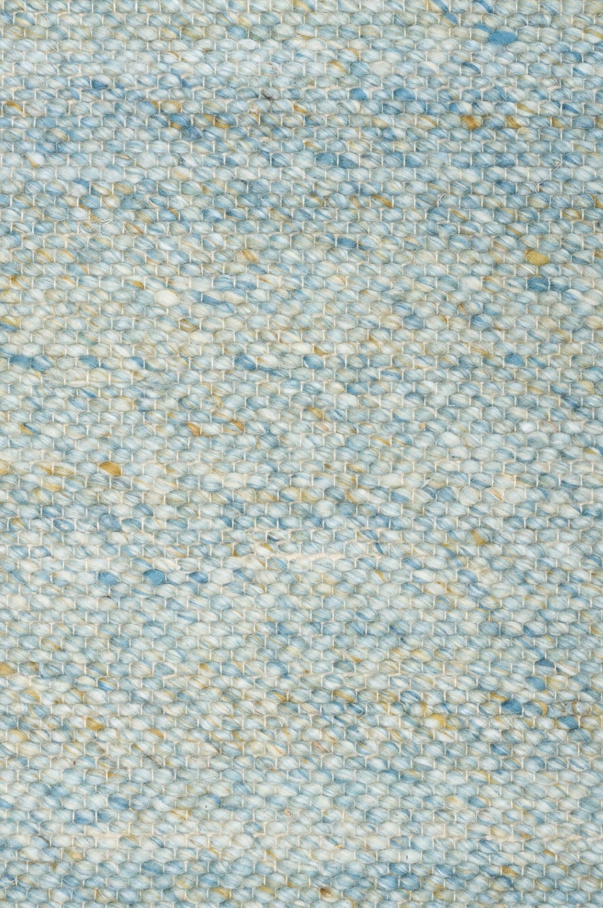 Surface close-up of light blue area rug with speckled texture and dense woven finish.