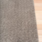 Gray shaggy rug with dense plush fibers and bound edge