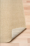 Beige textured area rug corner with bound edge and looped weave