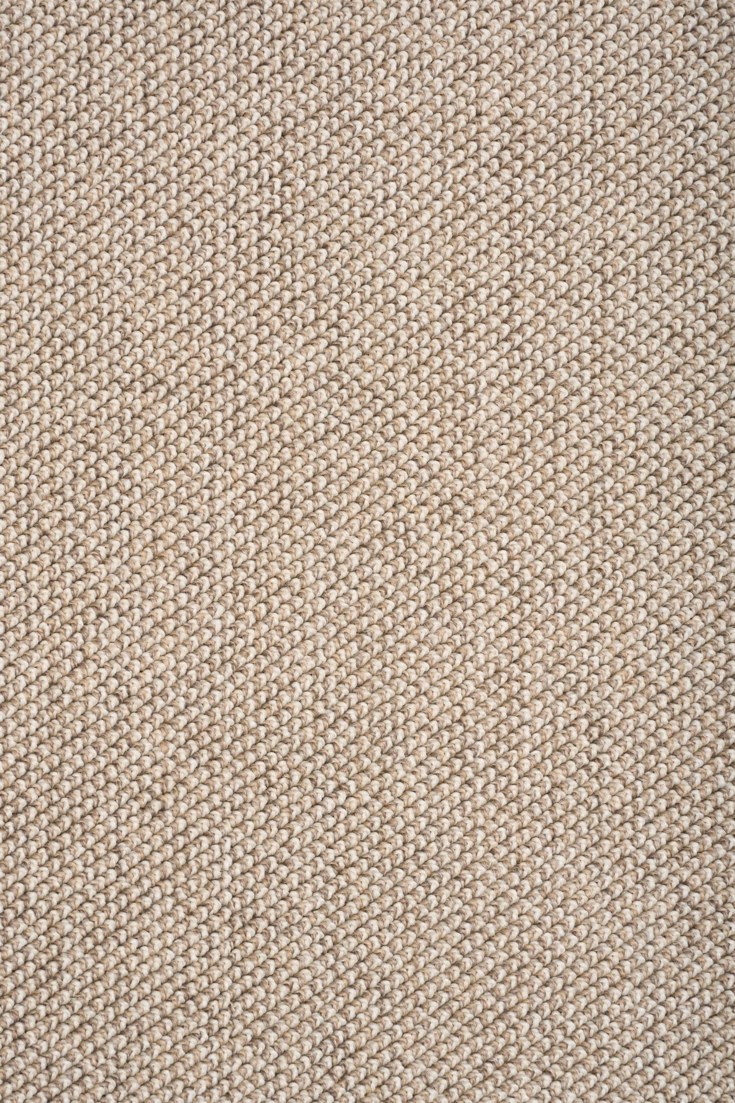 Light brown textured rug weave close-up with fine looped pattern