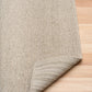 Light brown textured area rug with woven border and corner detail