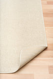 Cream woven area rug with short textured pile and neatly finished edge