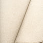 Cream woven area rug corner with rolled edge and fine loop texture