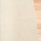 Cream woven area rug with squared border and tight, textured surface