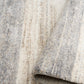 Bone grey rug fabric close-up with bound edge and fine mottled texture