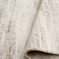 Bone cream area rug with short textured pile and distressed stripe pattern, rolled edge