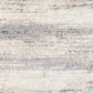 Grey and cream abstract area rug close-up, layered stripes and speckled texture