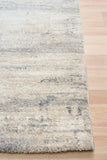 Grey and cream abstract area rug with short textured pile and visible border edge