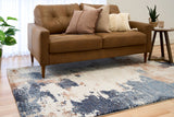 Rectangular area rug with distressed blue, cream, and rust abstract pattern