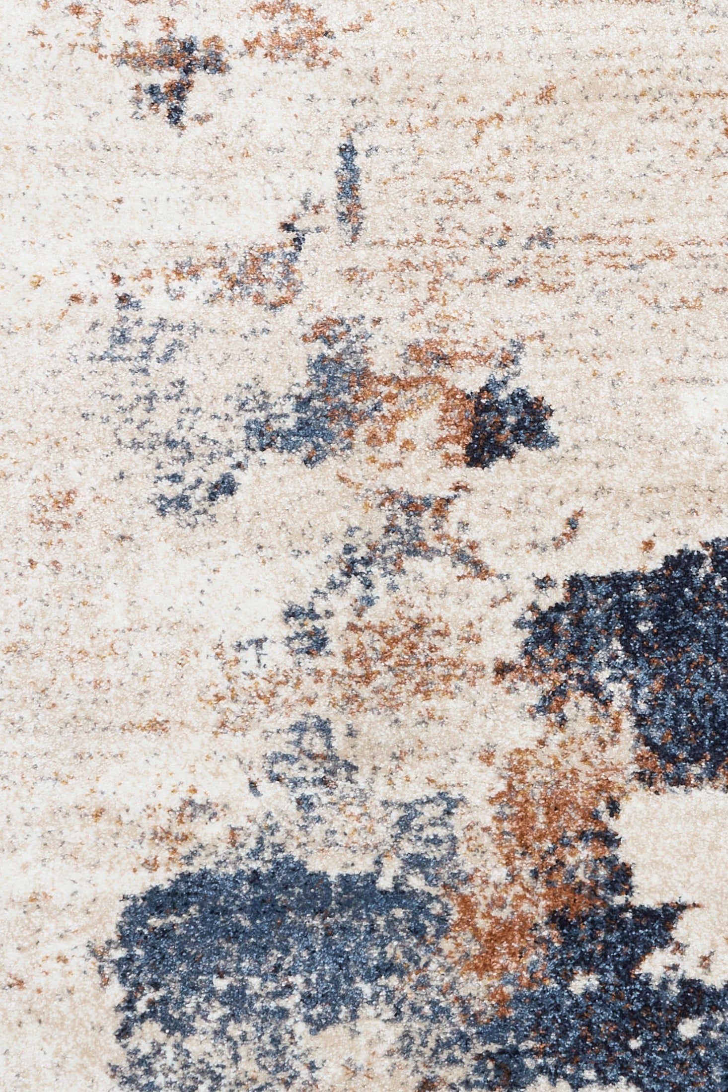 Surface close-up of abstract rug showing cream, blue, and rust mottled texture
