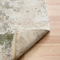 Green and cream abstract area rug with visible stitched border and rolled edge