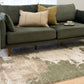 Green and cream abstract area rug on hardwood floor, distressed mottled pattern
