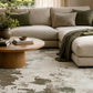 Green and cream abstract area rug on hardwood floor, wide coverage view