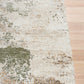 Green and cream abstract textured area rug corner with low pile edge binding