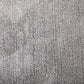 Grey rug close-up showing dense textured pile and mottled surface