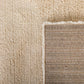 Ivory area rug edge with woven binding and textured pile border