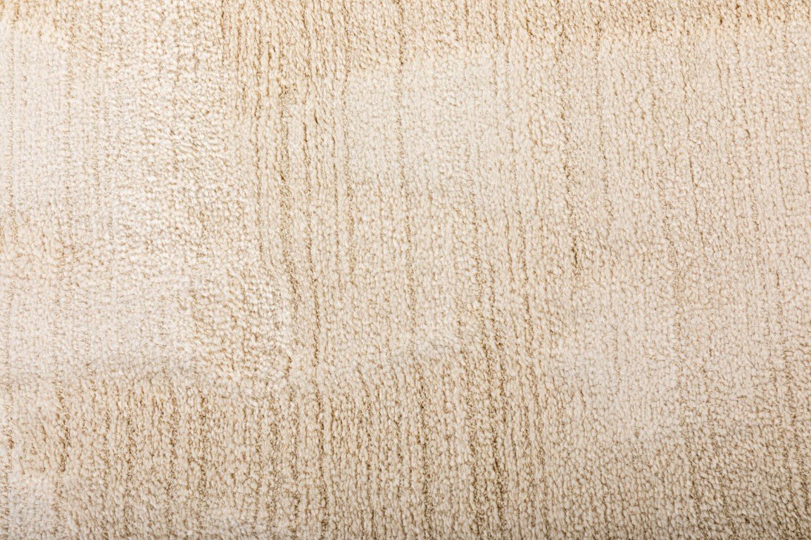 Ivory shaggy area rug surface with fine vertical texture and dense pile
