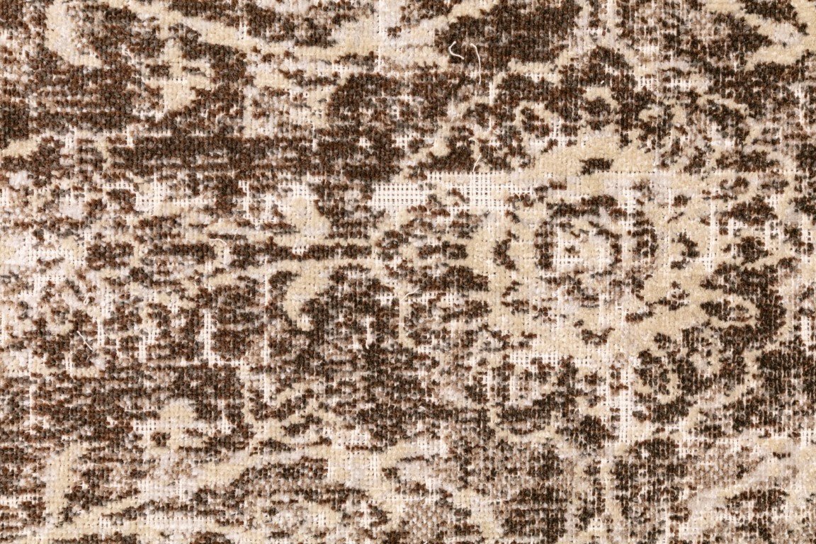 Close-up of ash grey and off-white distressed abstract rug pattern