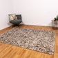 Rectangular area rug with ash grey and off-white abstract distressed pattern