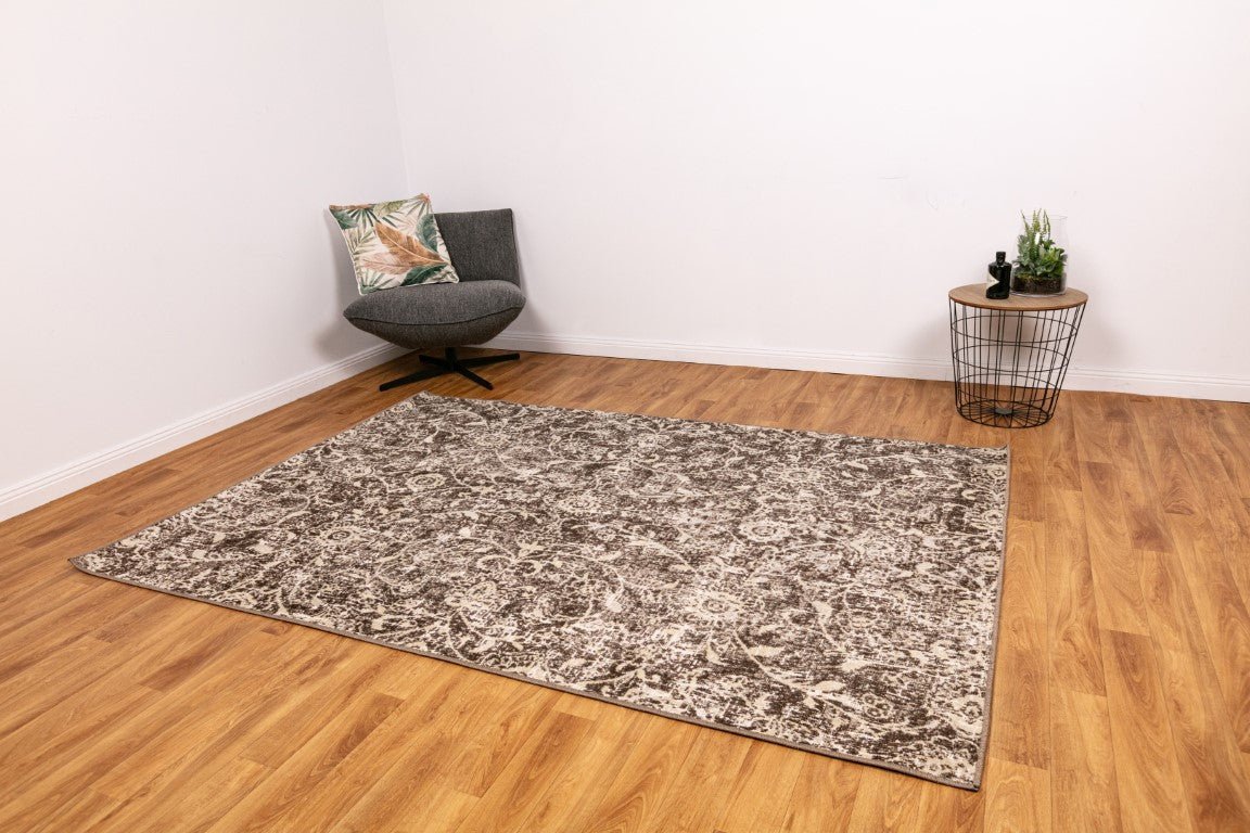 Rectangular area rug with ash grey and off-white abstract distressed pattern