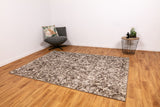Rectangular area rug with ash grey and off-white abstract distressed pattern