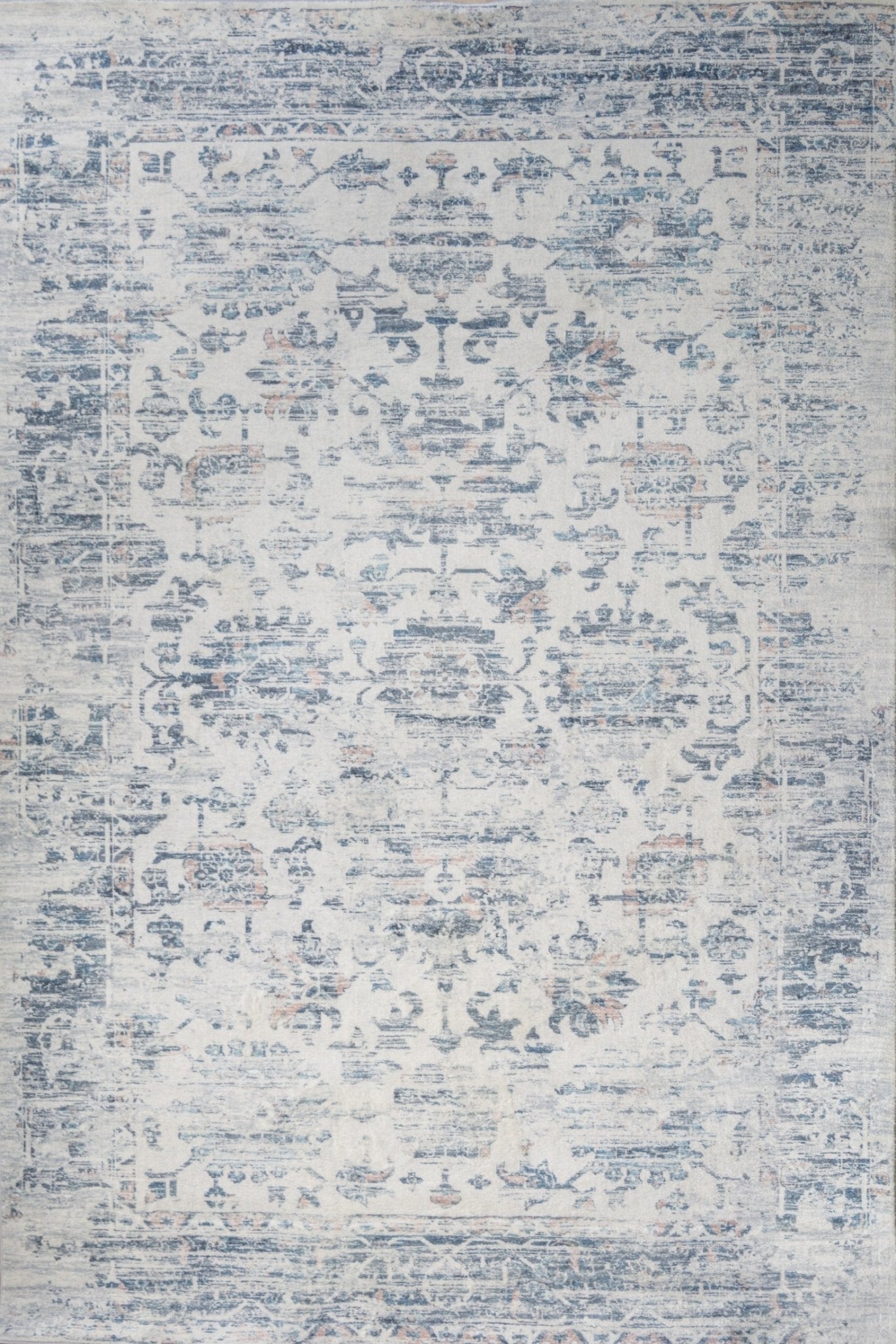 Ivory and blue abstract distressed rug with faded pattern