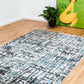 Grey-blue abstract area rug with distressed geometric pattern