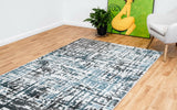 Grey-blue abstract area rug with distressed geometric pattern