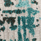 Textured abstract motif rug in teal and dark teal on a light gray base