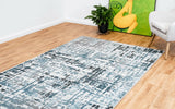 Modern abstract floor rug with teal and blue blocks on a light background